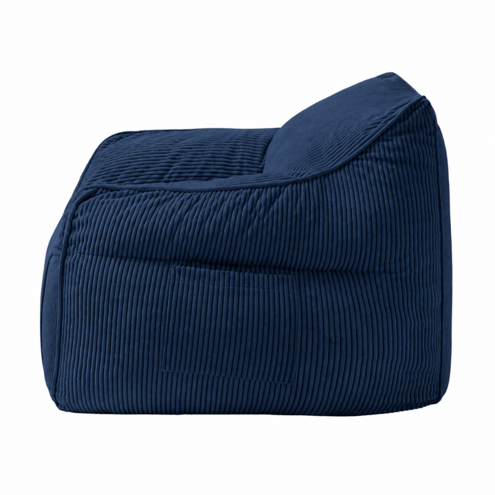 Pouf fauteuil en velours côtelé bleu foncé, vue de côté, coutures verticales et renforts.
