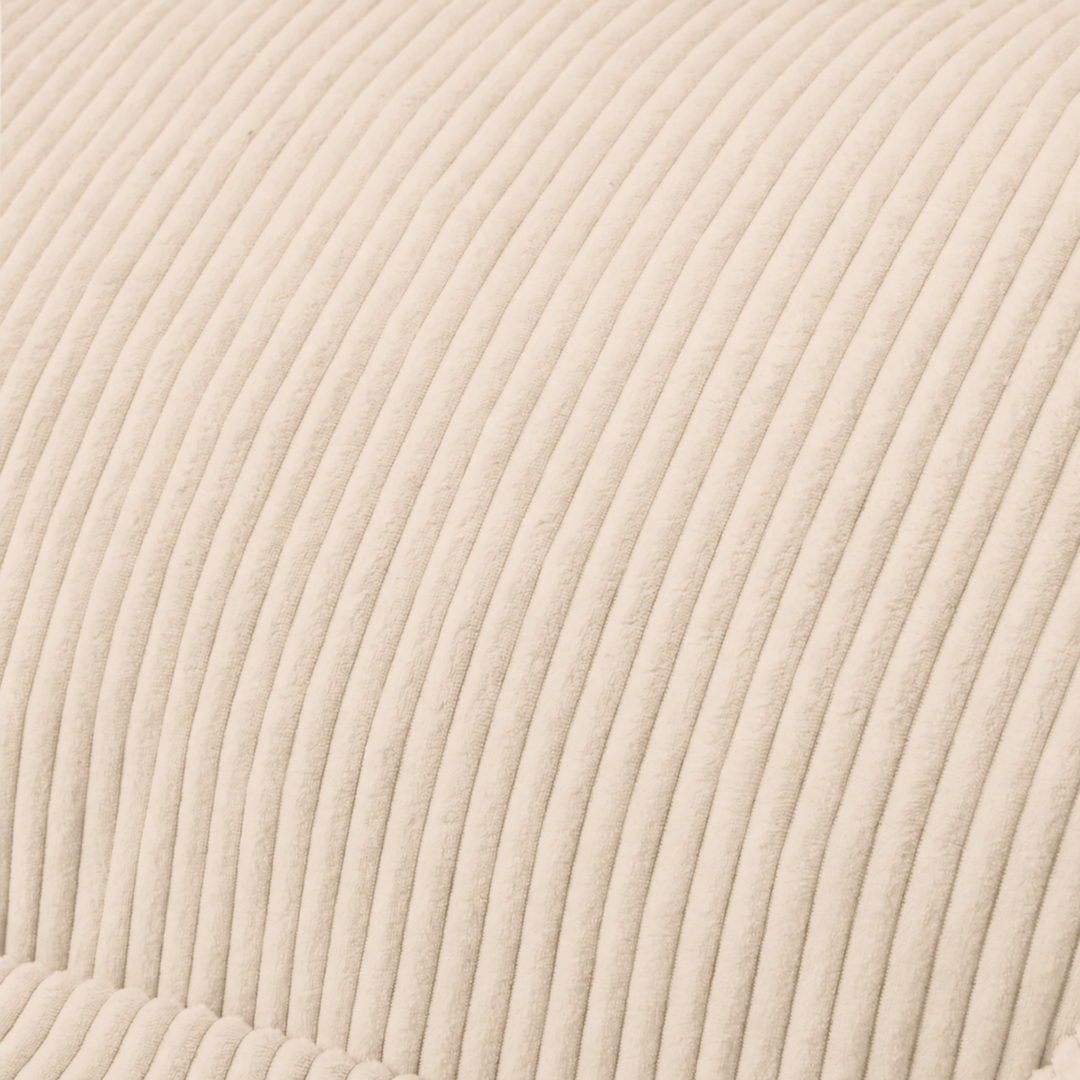 Gros plan du tissu du pouf en velours côtelé beige