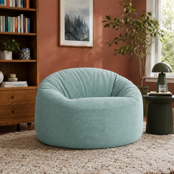 Pouf rond en velours côtelé assise rembourrée, dans un salon