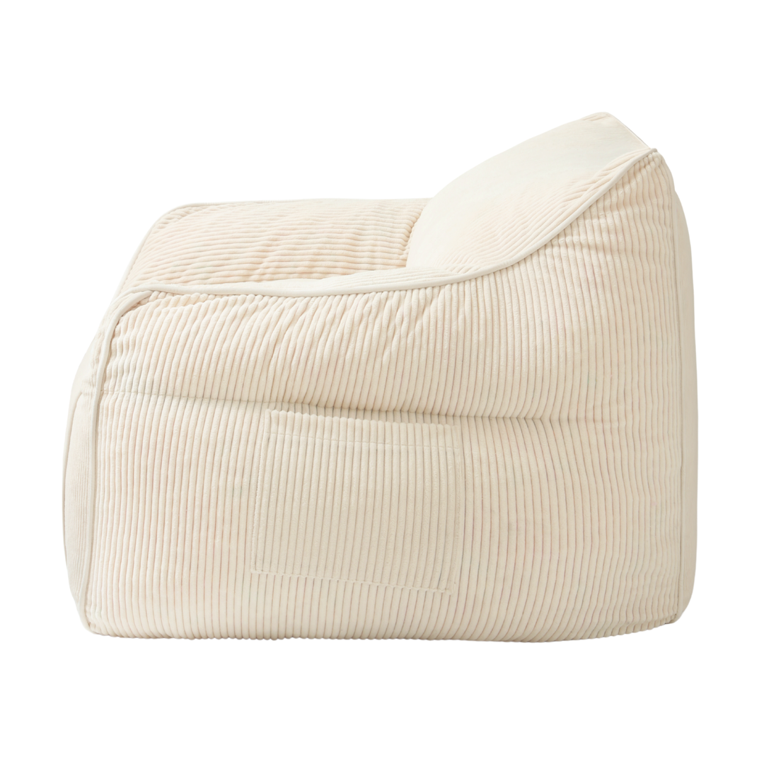 Pouf fauteuil en velours côtelé blanc cassé, vue de côté, coutures verticales et renforts.