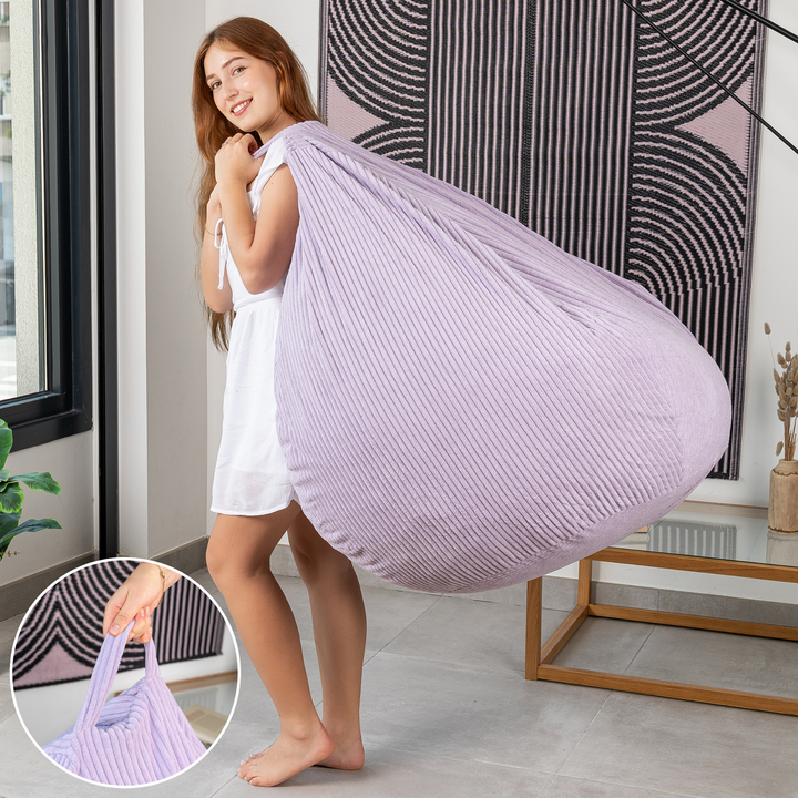 Femme soulevant le pouf poire déhoussable en velours côtelé déhoussable par sa poignée.