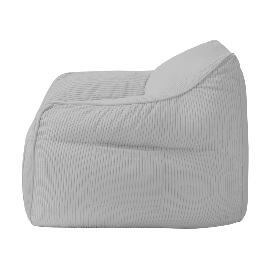 Pouf fauteuil en velours côtelé gris clair, vue de côté